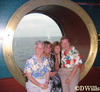 The girls pose in front of the port hole