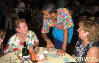 Sachin entertains Linda and Sandy with card tricks.